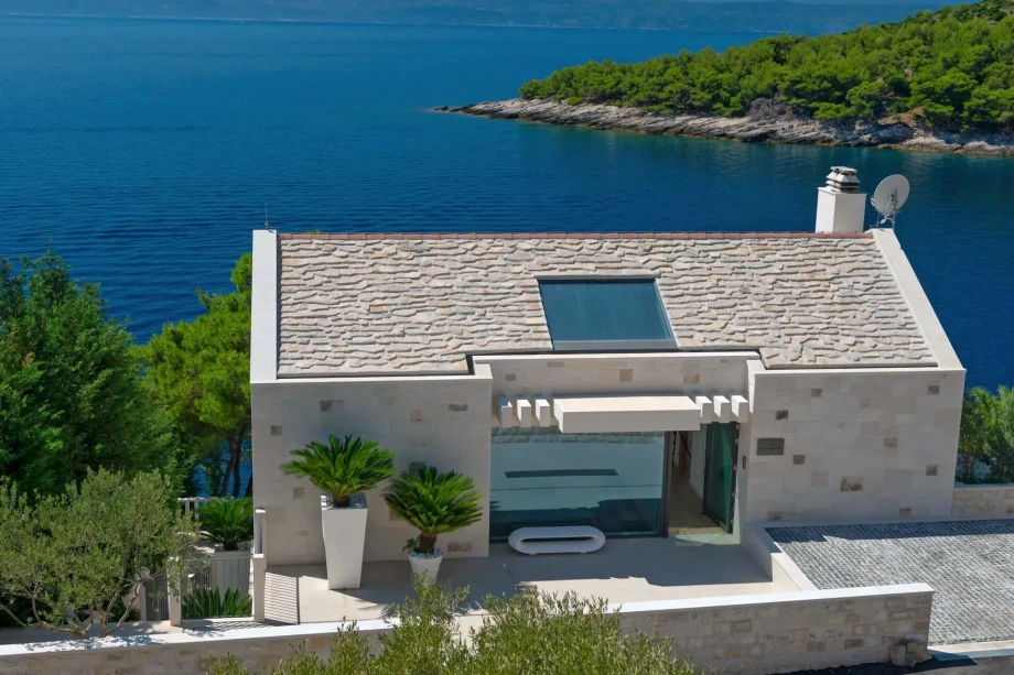 Elegant seaside villa Acoona on island Brac featuring a grand terrace that overlooks the blue sea.