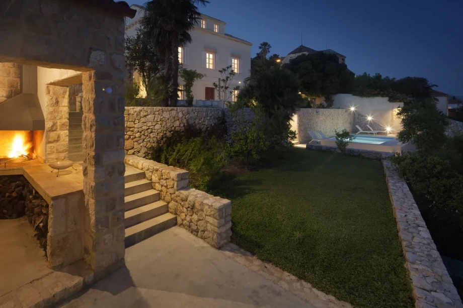Fireplace and swimming pool in front of a luxury villa in Dubrovnik