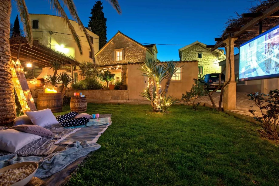 A tranquil backyard at Villa Sweet Home in Split Old Town, complete with a screen and a hammock for leisure.
