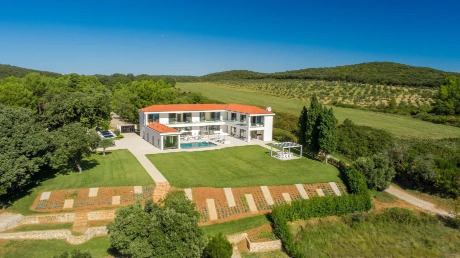 Surrounded by lush greenery, the luxury villa Ultima in Istria is set amidst fields and trees, creating a peaceful retreat.