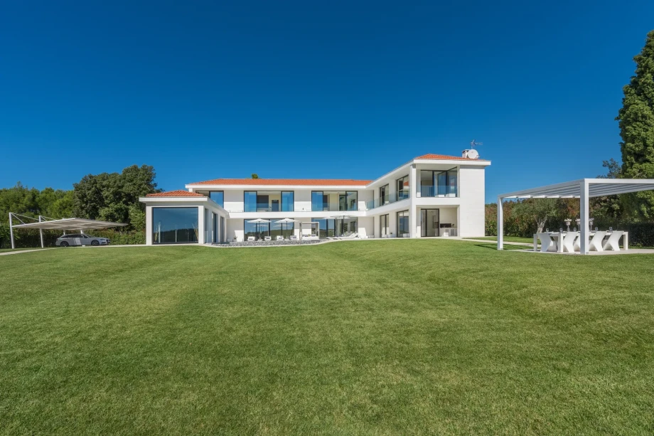 Exterior view of Luxury Villa Ultima for sale, located in Istria, showcasing modern architecture and lush surroundings.