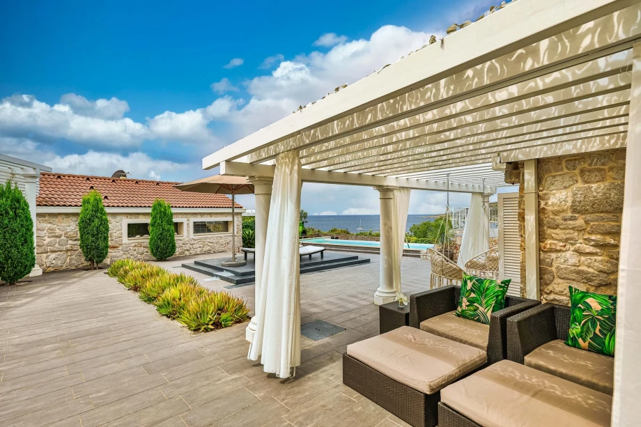 Courtyard with sun loungers on the terrace of Croatia's luxury holiday villa by the sea and beach Mala Rina