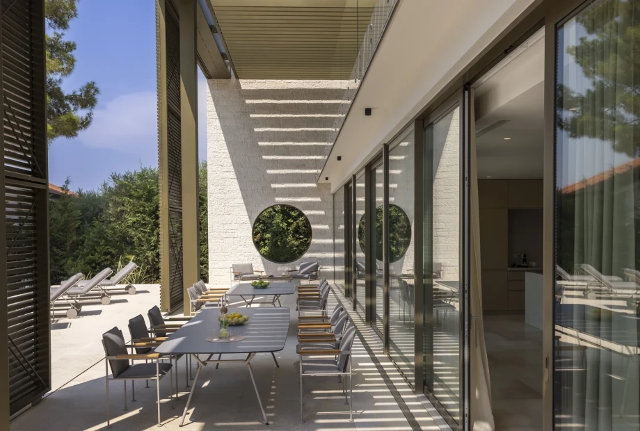 Charming outdoor patio at Villa Lani, Poreč, Istria, with comfortable chairs and tables for enjoying the beautiful views.