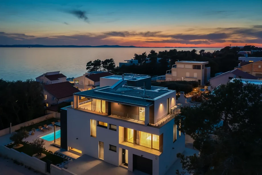 Aerial sunset view on the property of Villa Happiness with the private heated pool close to the sea in the Zadar area