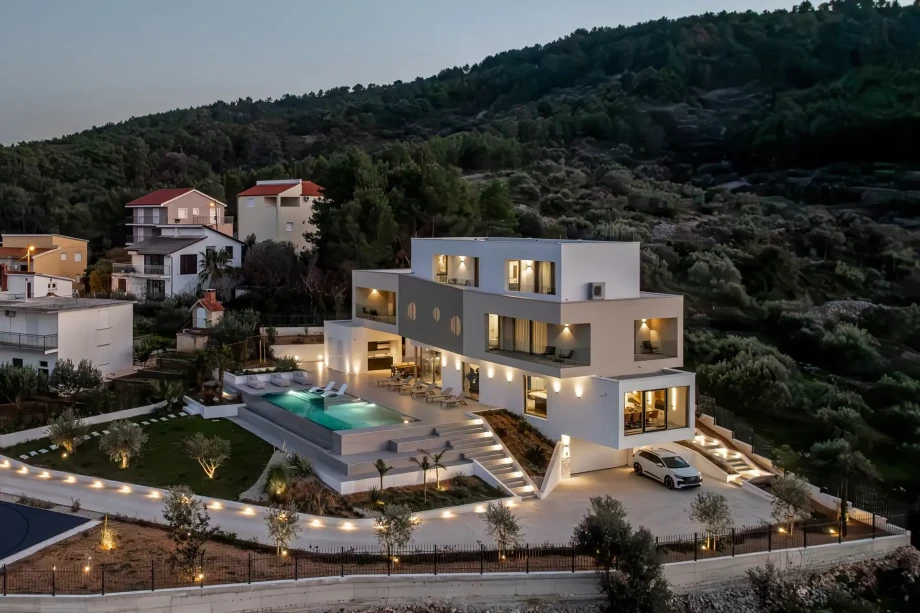 Vista Maris, a luxury villa in Trogir, showcasing a contemporary design with a swimming pool and a driveway