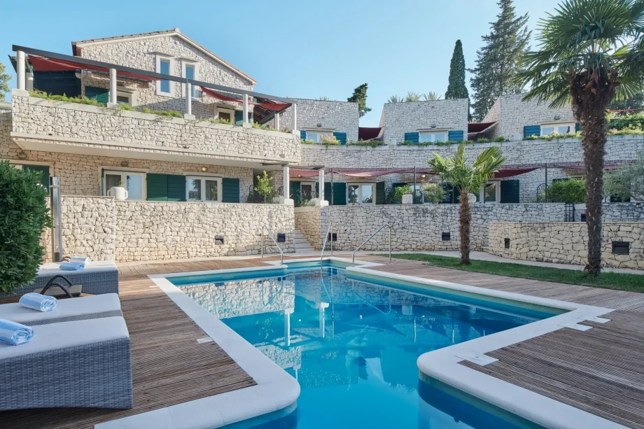 Villa Priska, highlighting a house surrounded by a pool and a comfortable patio for leisure activities
