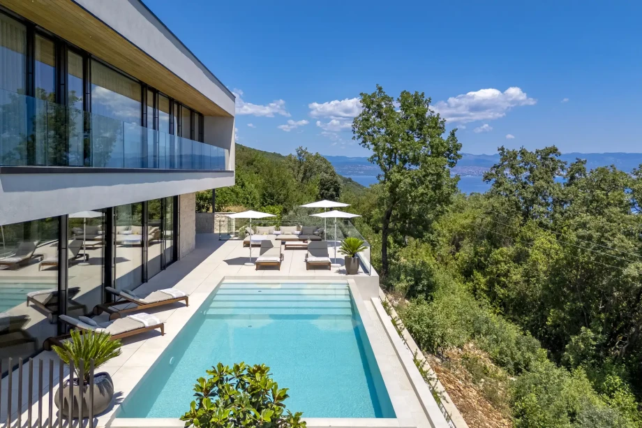 Stylish villa with a pool and sun loungers, nestled near Opatija, offering a perfect retreat for travelers in Croatia.