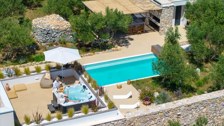 Stunning aerial shot of Villa Oliveto, featuring a serene pool and Jacuzzi in the island's natural beauty.
