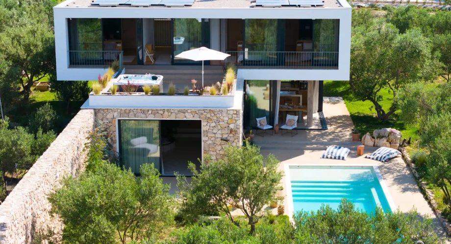 Modern villa on Solta Island featuring a luxurious pool and spacious terrace for relaxation.